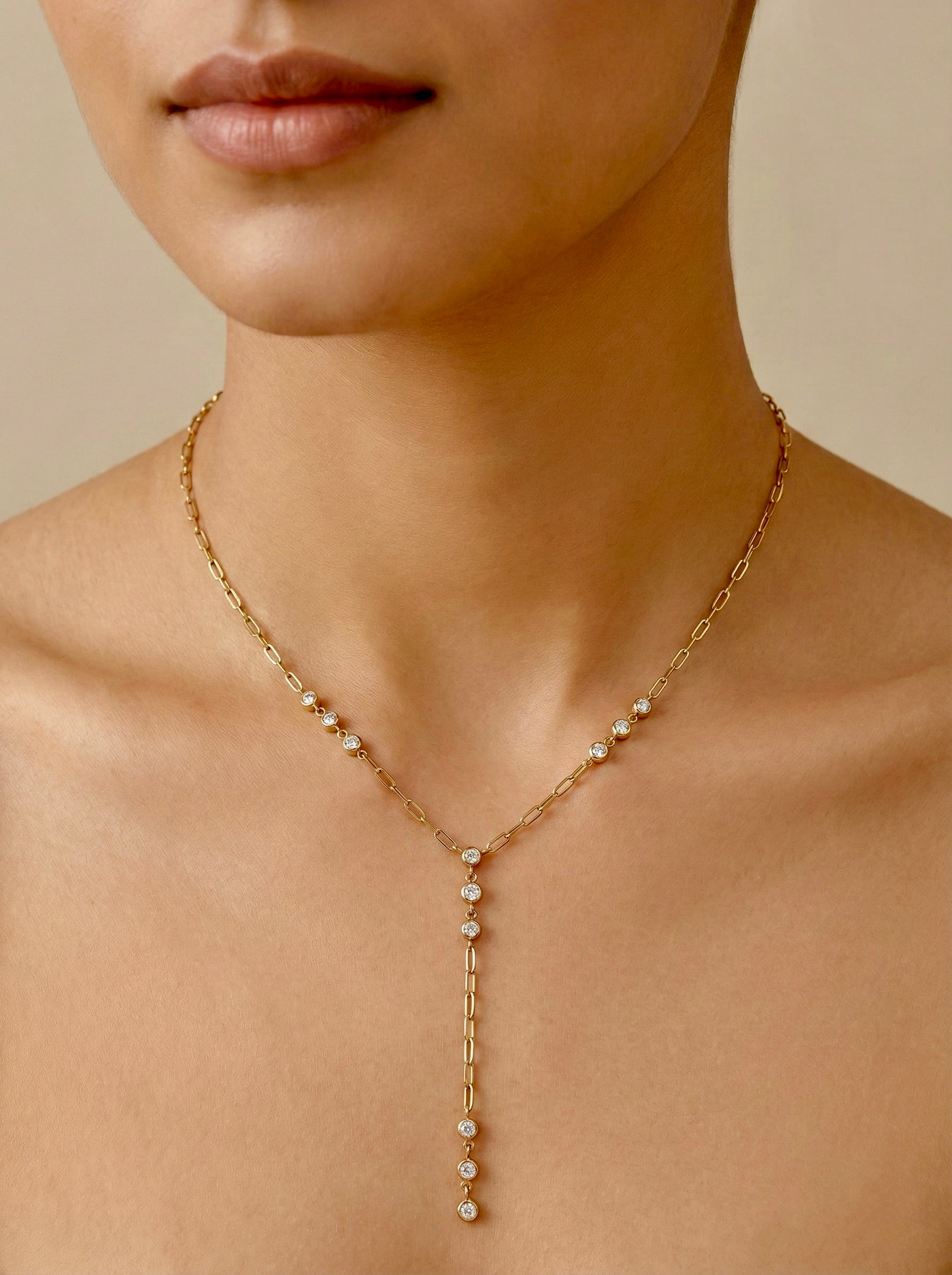Close-up on model of cubic zirconia Elowen stations on gold anti-tarnish necklace chain