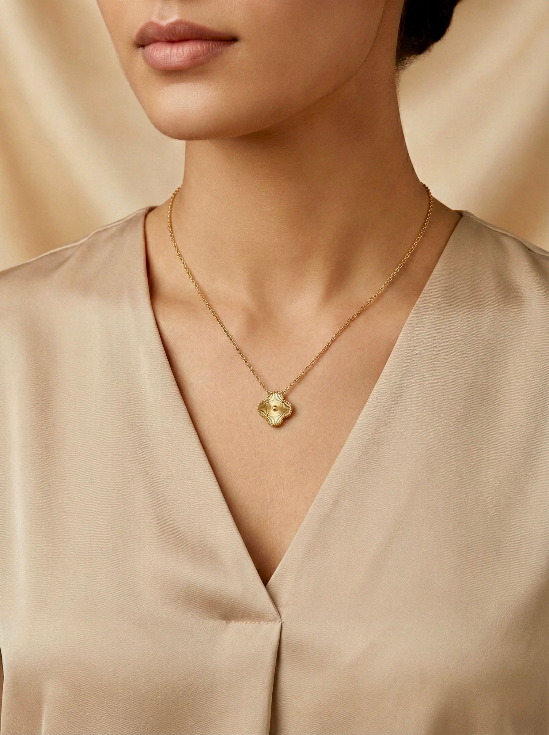 gold Florielle clover pendant necklace styled on model fine chain for modern minimal styling