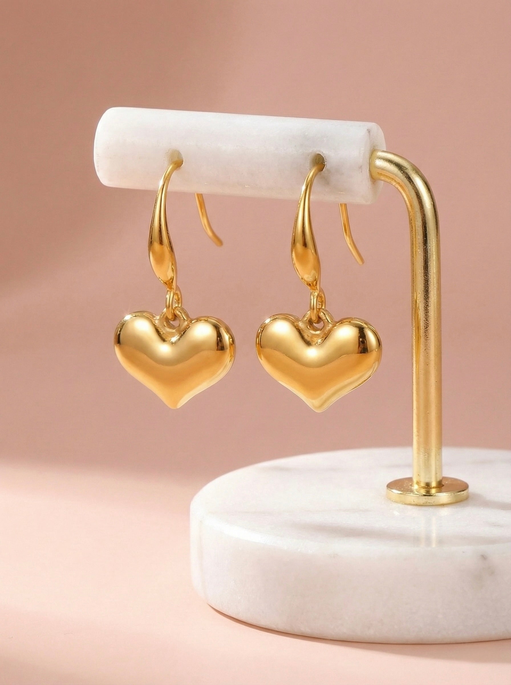 Side view of Amour Drops anti-tarnish gold heart drop earrings for women