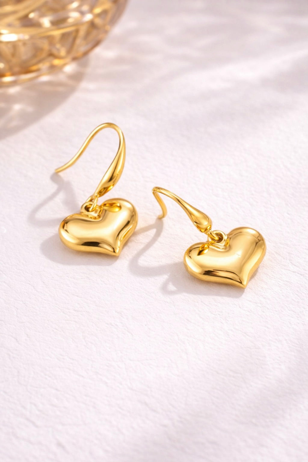 Close-up of Amour Drops gold heart earrings showing detailed drop silhouette and anti-tarnish finish
