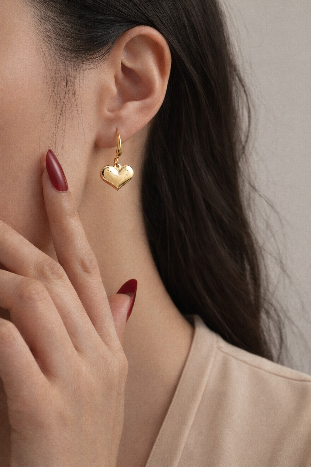 Amour Drops heart gold earrings worn on model with elegant everyday style