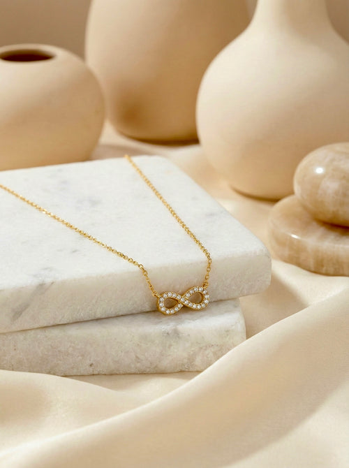 Close-up of Ananta Infinity necklace detail with smooth finish