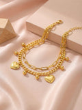 Close-up of anti-tarnish gold heart charm bracelet detail