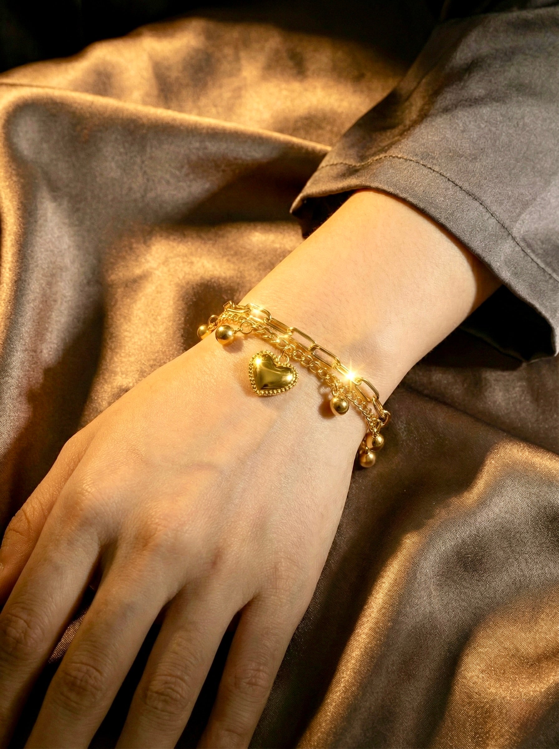 Gold plating heart charm detail on lightweight bracelet