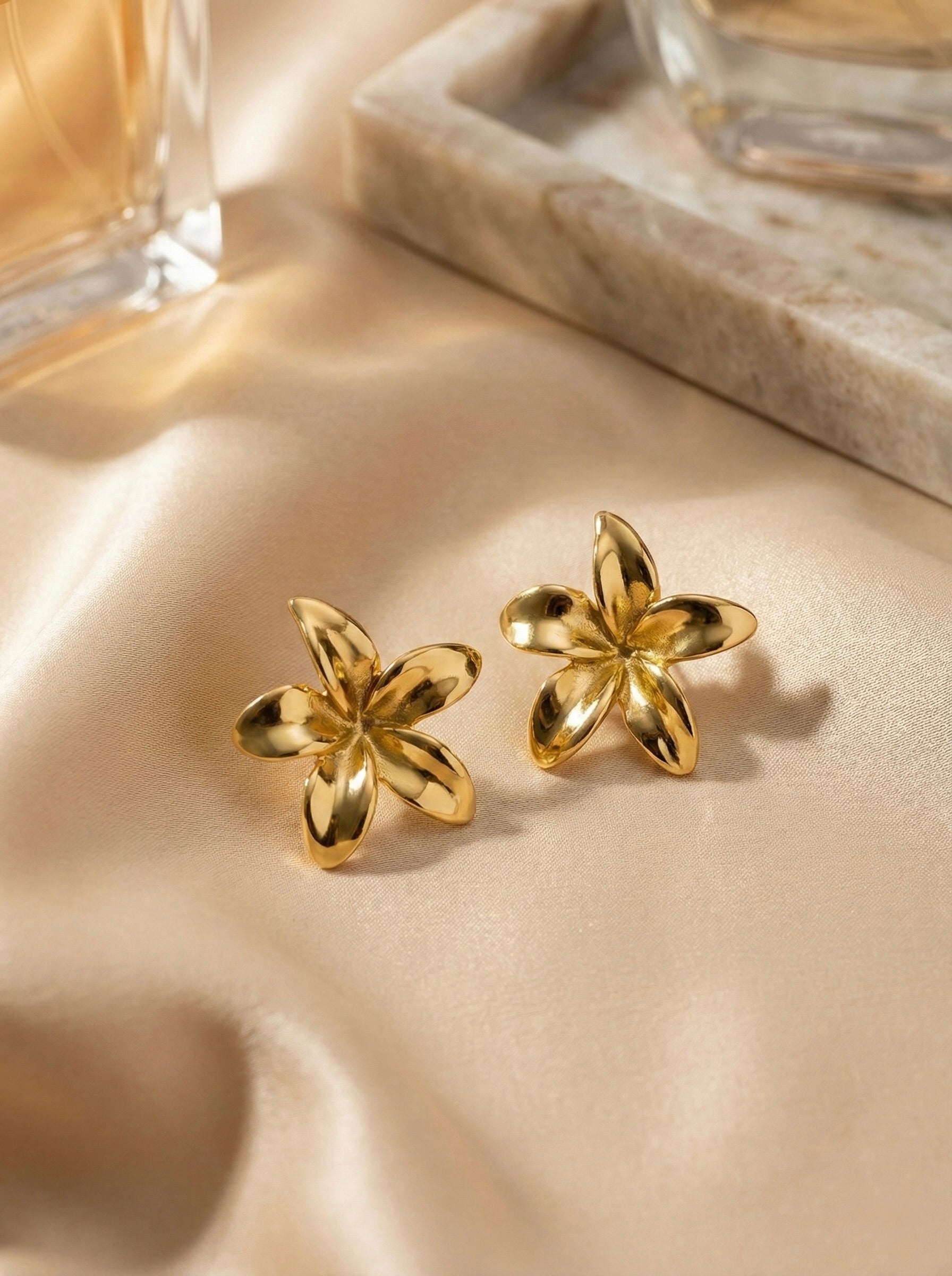 Close-up of anti-tarnish gold floral stud earrings detail
