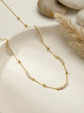 Caelisse Curve gold CZ necklace with anti-tarnish finish and minimal curved stone design
