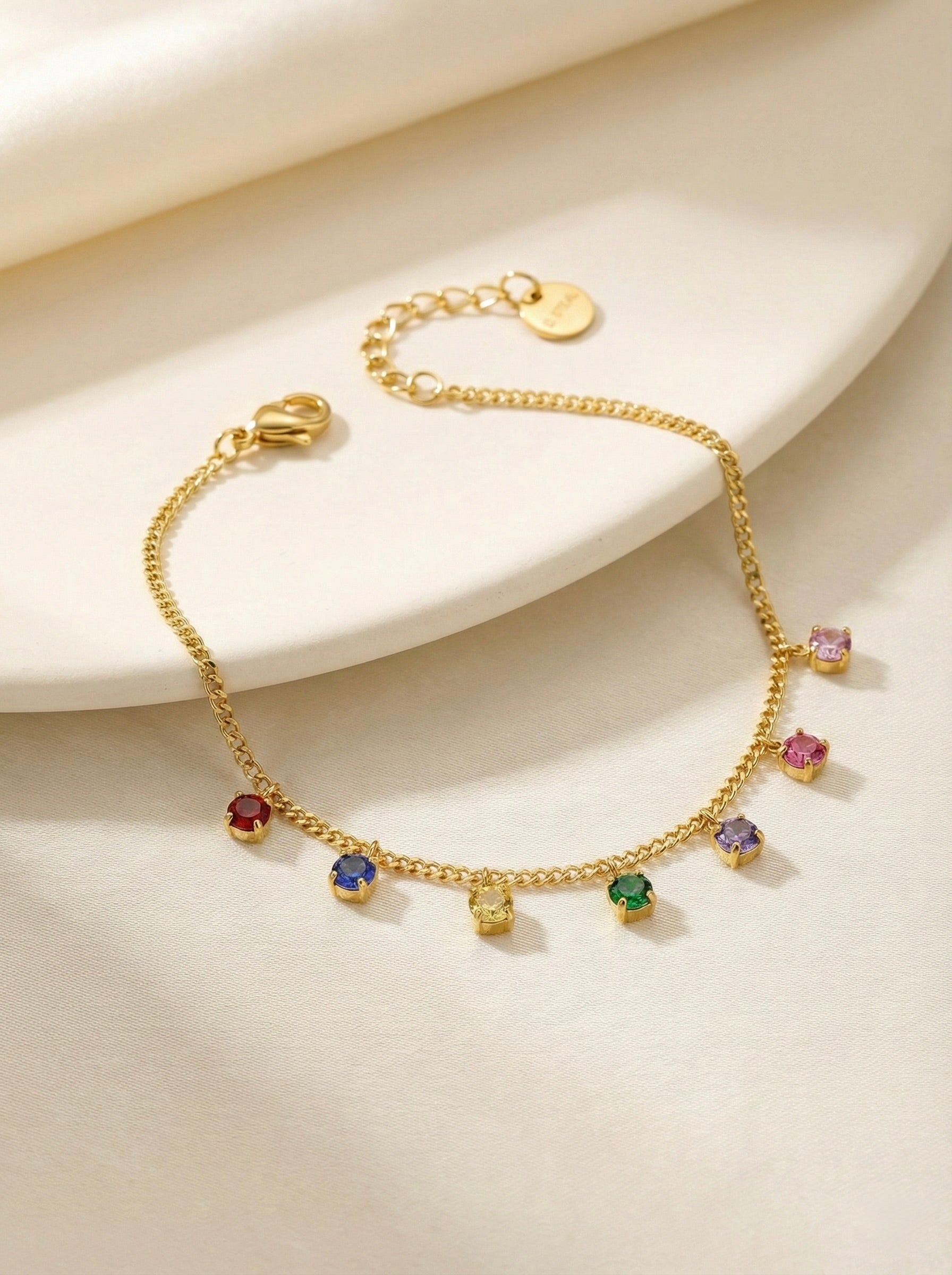 Close-up of multi-colour CZ stones on gold anti-tarnish bracelet detail