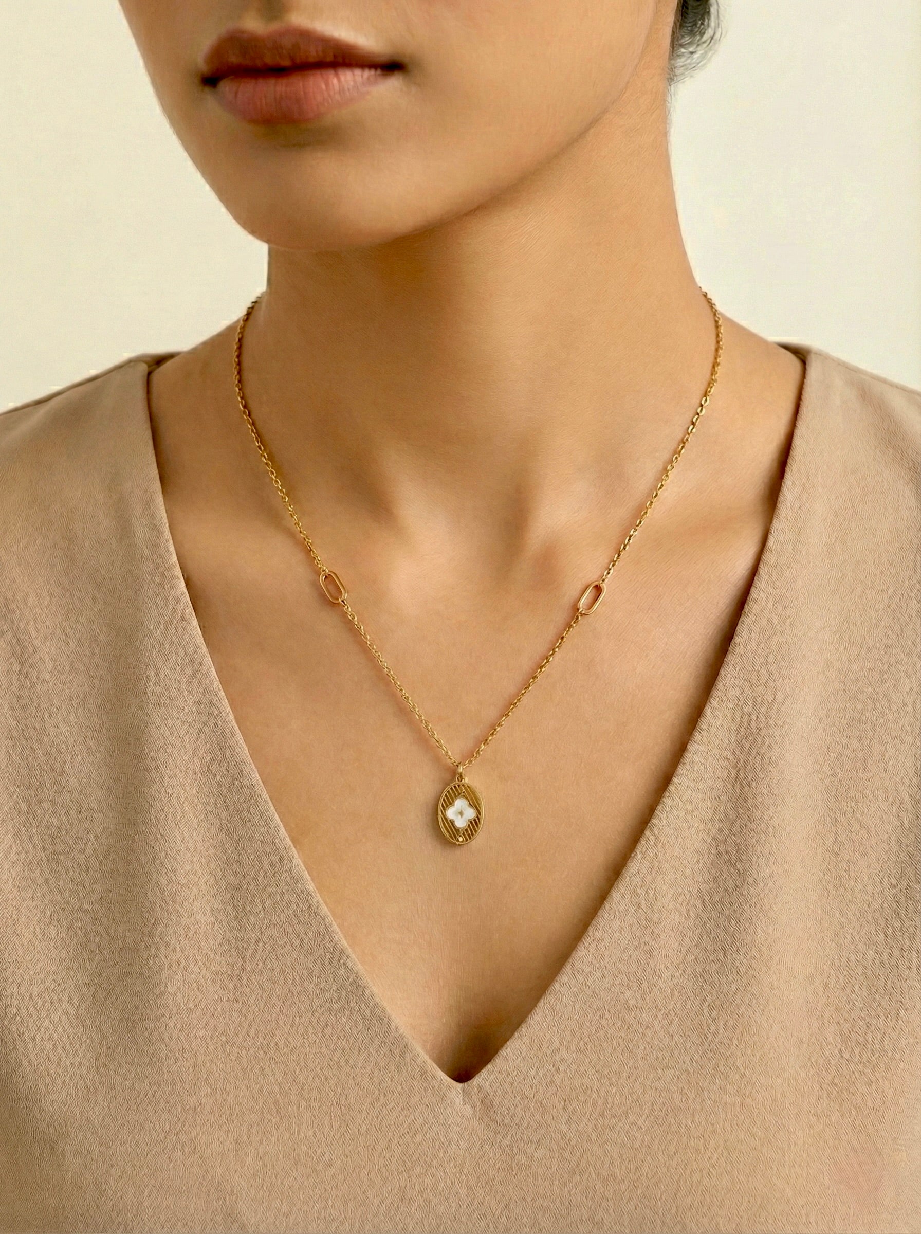 Eliora Bloom gold medallion necklace with floral motif and anti-tarnish finish on model by Sajheera