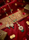 Emerald Pushpa Grace kundan necklace set with green bead drops and matching earrings in anti-tarnish gold finish