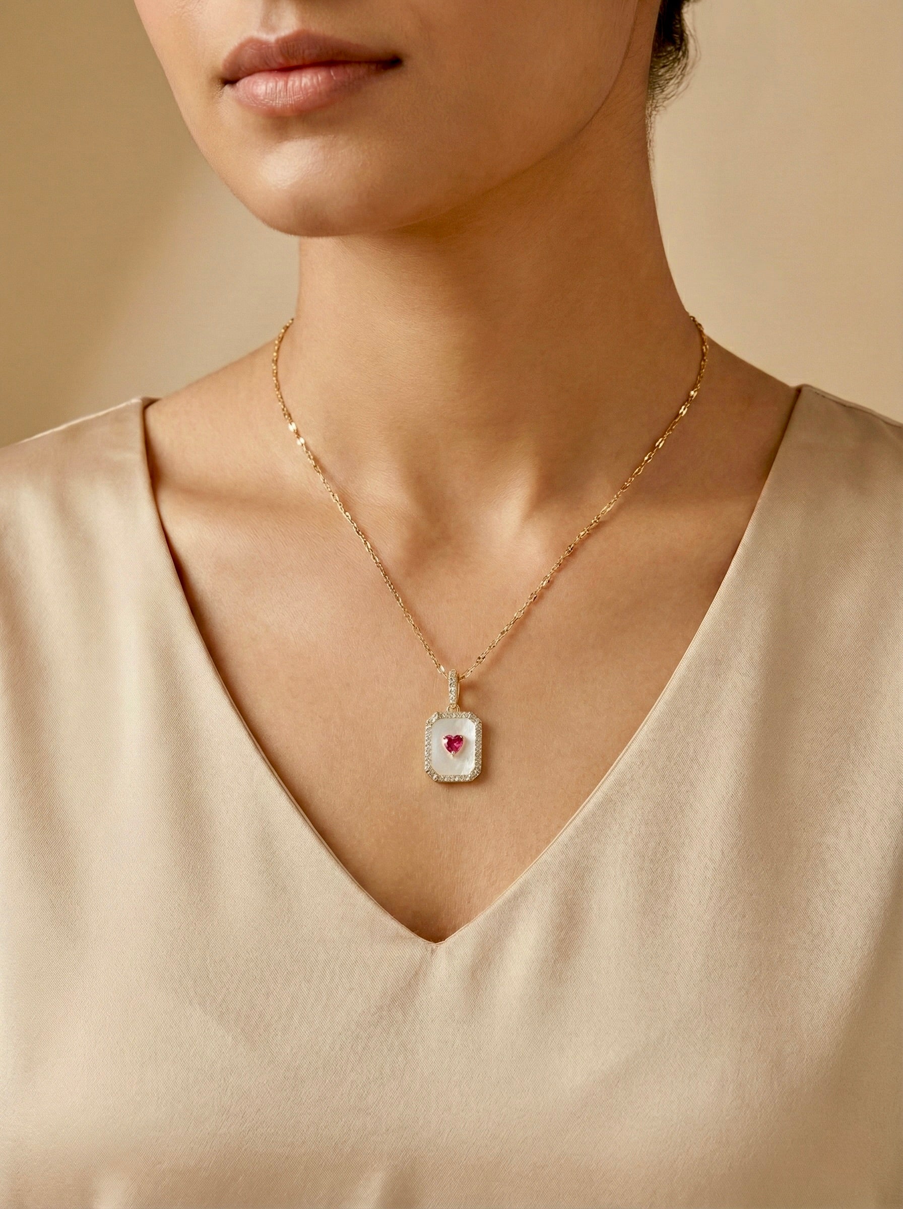 Emerelle crimson heart halo necklace with red/pink heart stone and gold anti-tarnish pendant on model