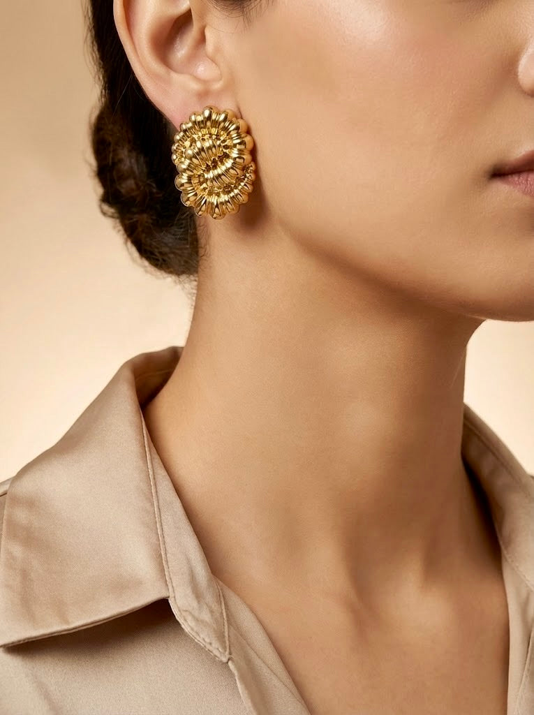 Radiant gold bloom statement earrings worn on model for festive styling