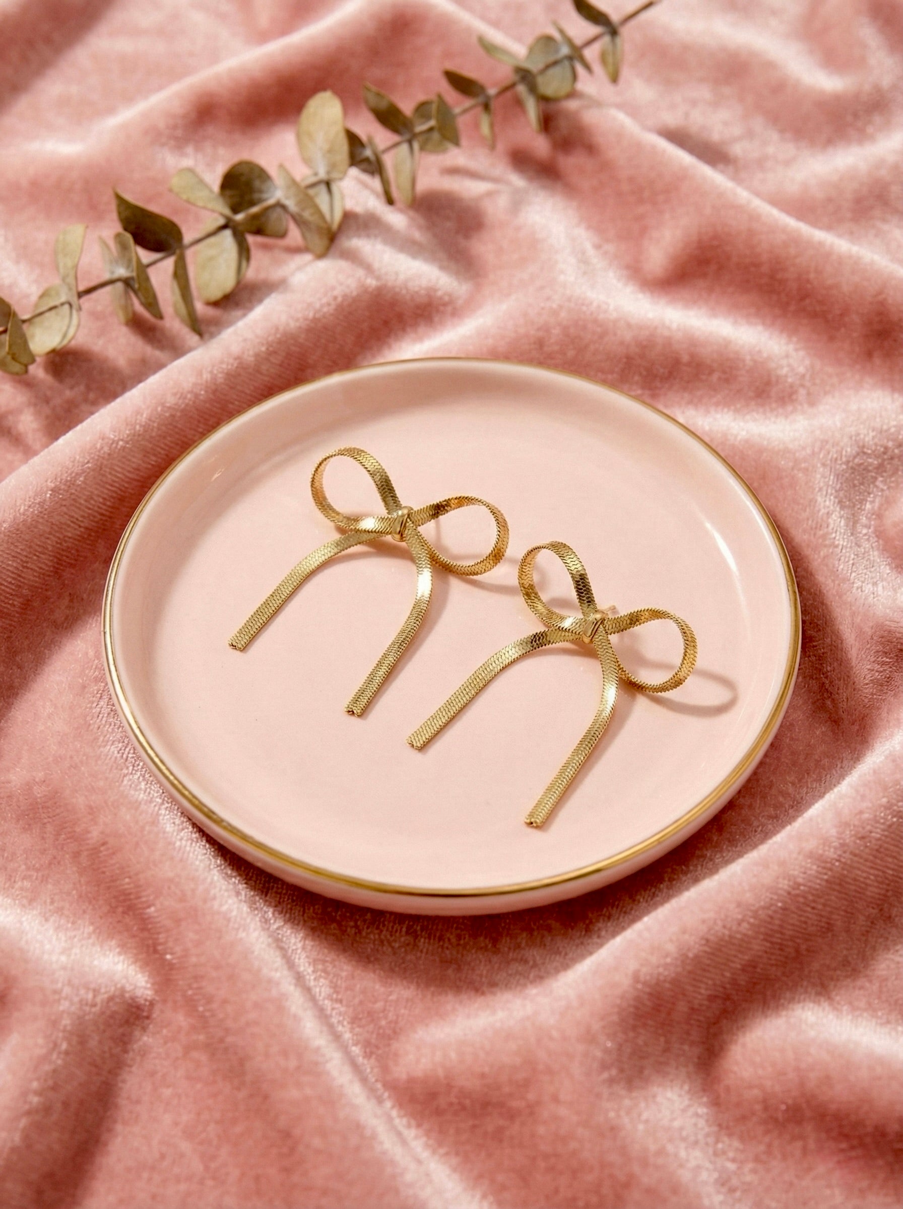 Gold bow drop earrings with anti-tarnish finish by Sajheera