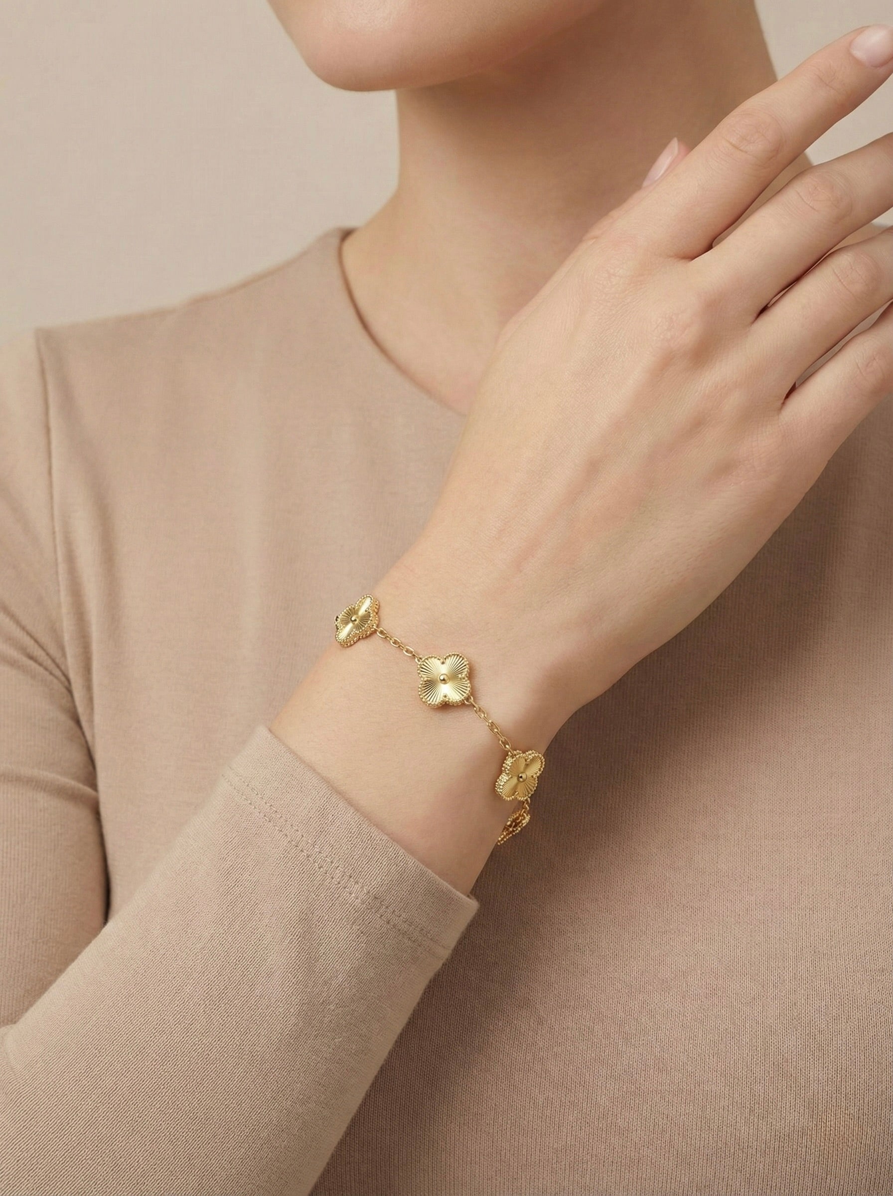 Gold clover charm florielle bracelet worn on wrist for minimal everyday styling
