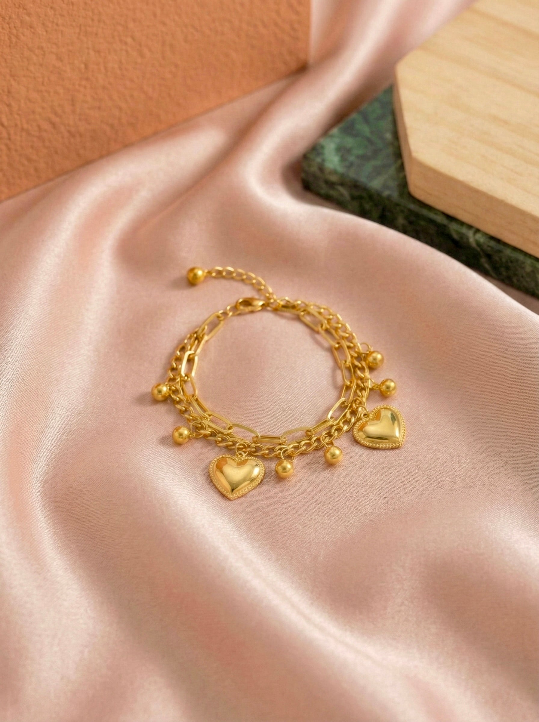 Gold heart charm bracelet with anti-tarnish finish by Sajheera