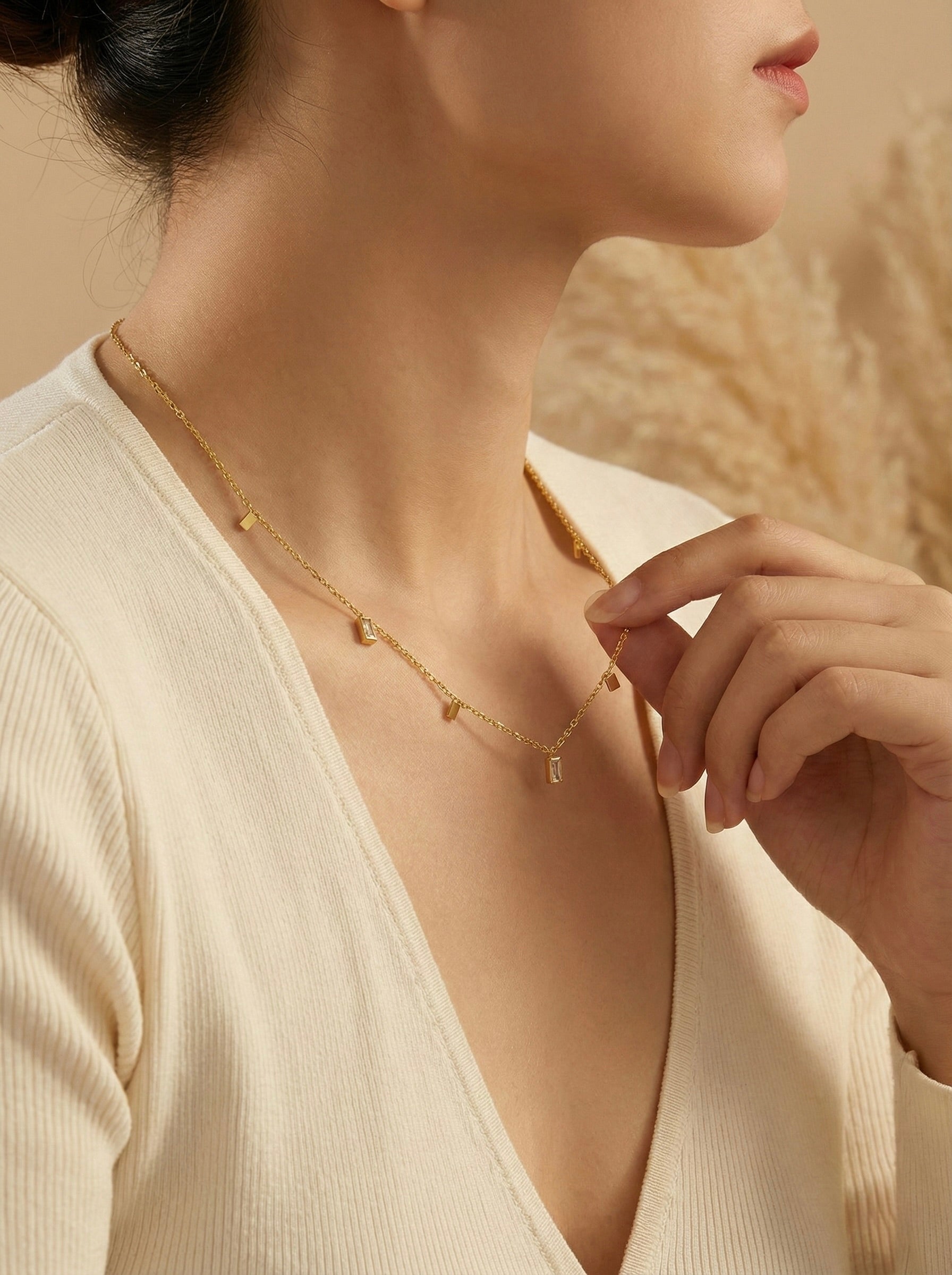 Side view of Lumera Quad anti-tarnish gold crystal station necklace