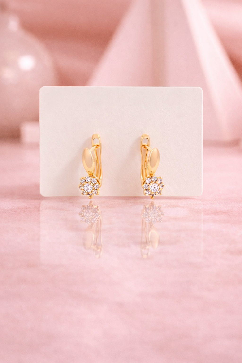 Front view of Lumiere Huggies anti-tarnish gold crystal cluster earrings