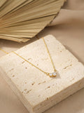 Lunara gold bow CZ pendant necklace with anti-tarnish finish on minimal chain