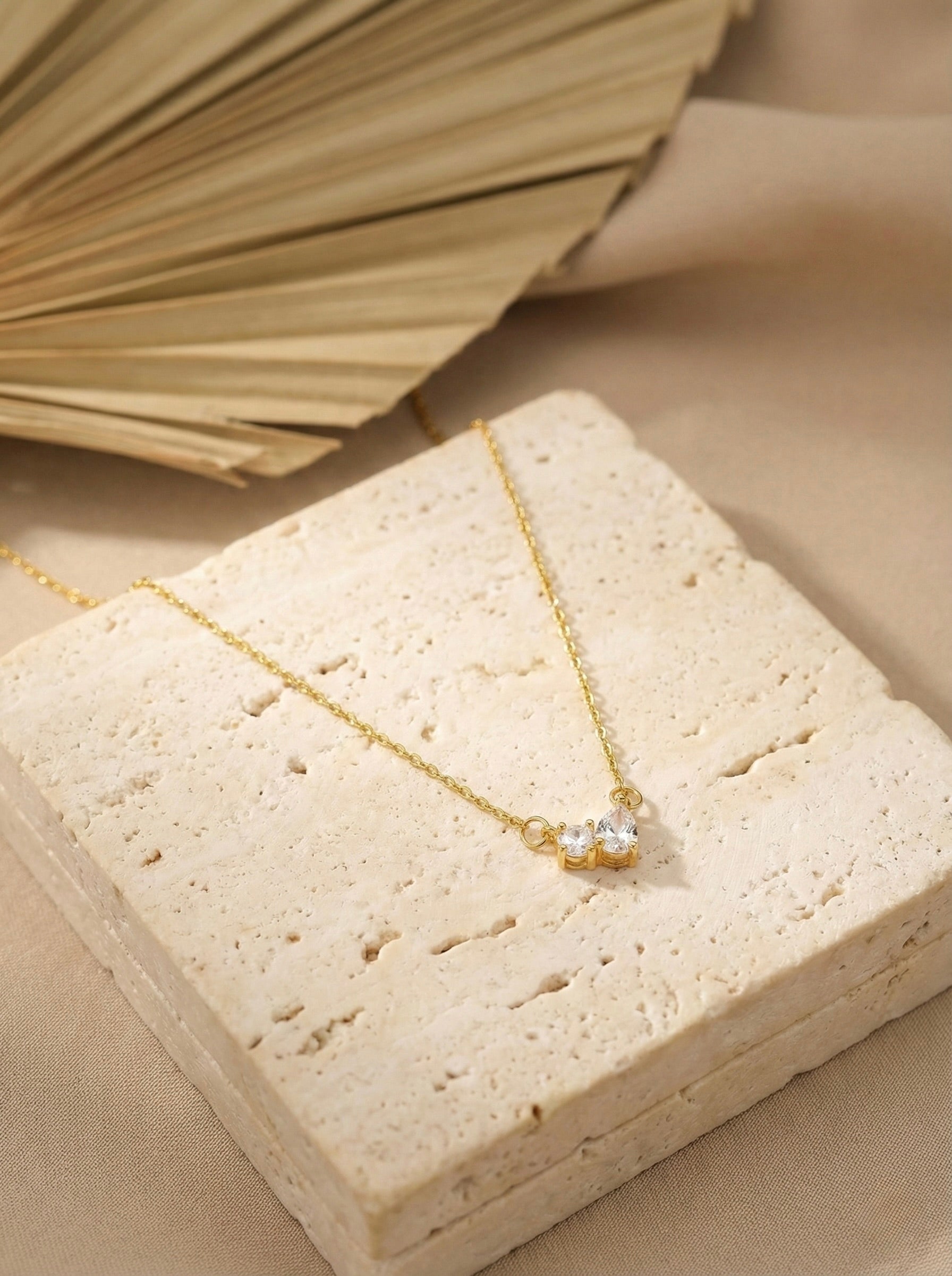 Lunara gold bow CZ pendant necklace with anti-tarnish finish on minimal chain