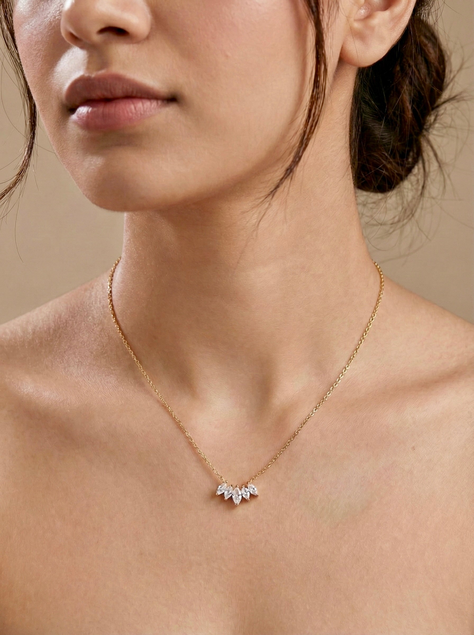 Minimal gold CZ cluster bloom necklace worn on model for everyday elegance