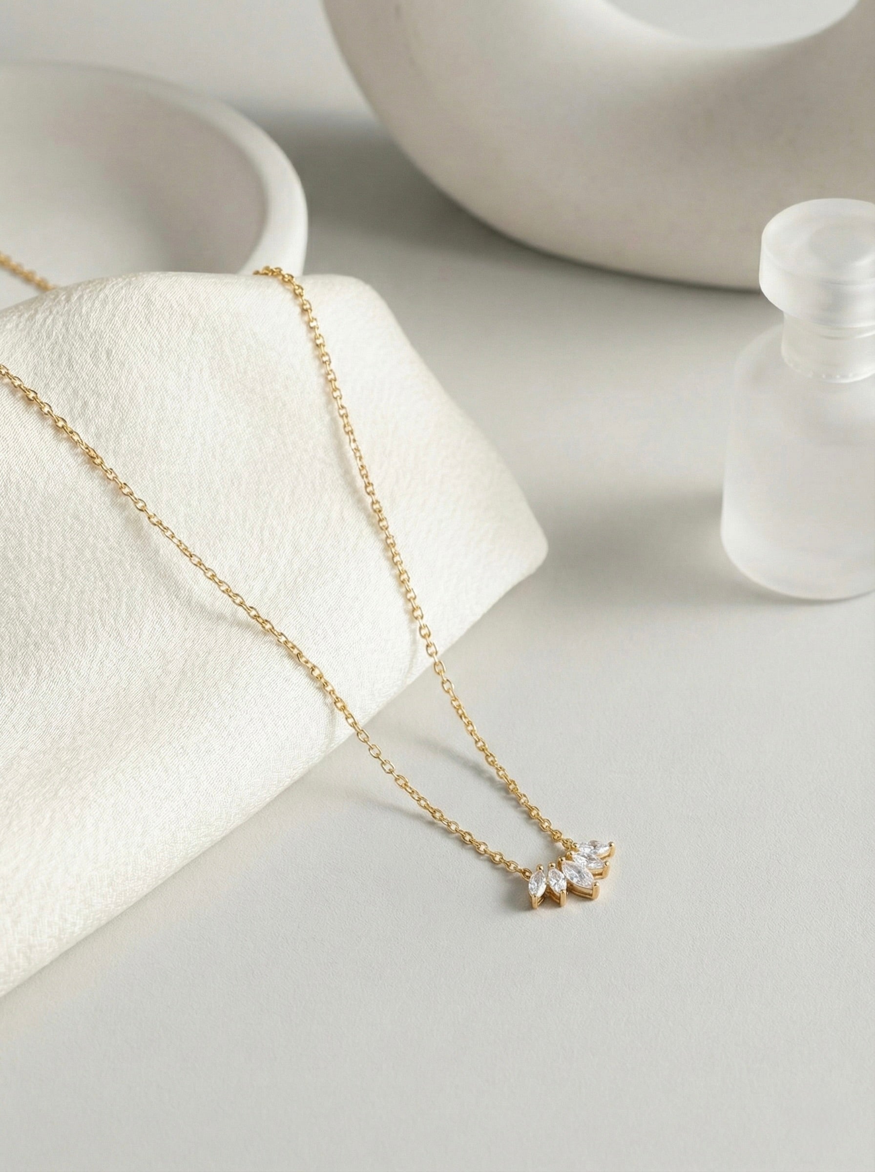 Side view of anti-tarnish gold lunea CZ bloom pendant necklace on fine chain