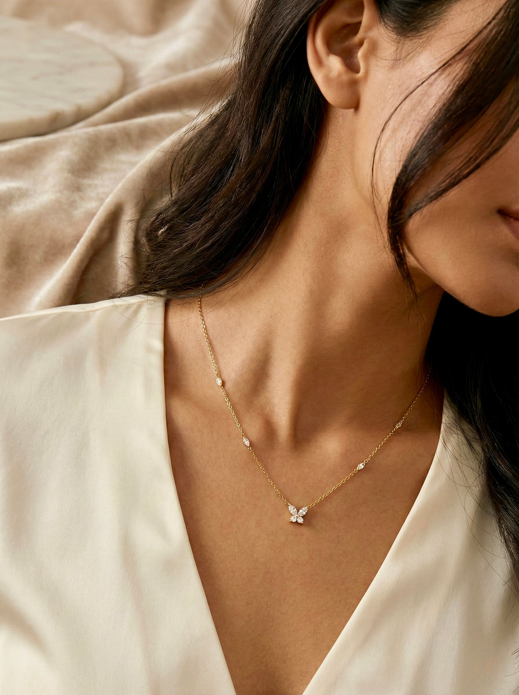 Minimal gold elira butterfly necklace styled on model for everyday elegance