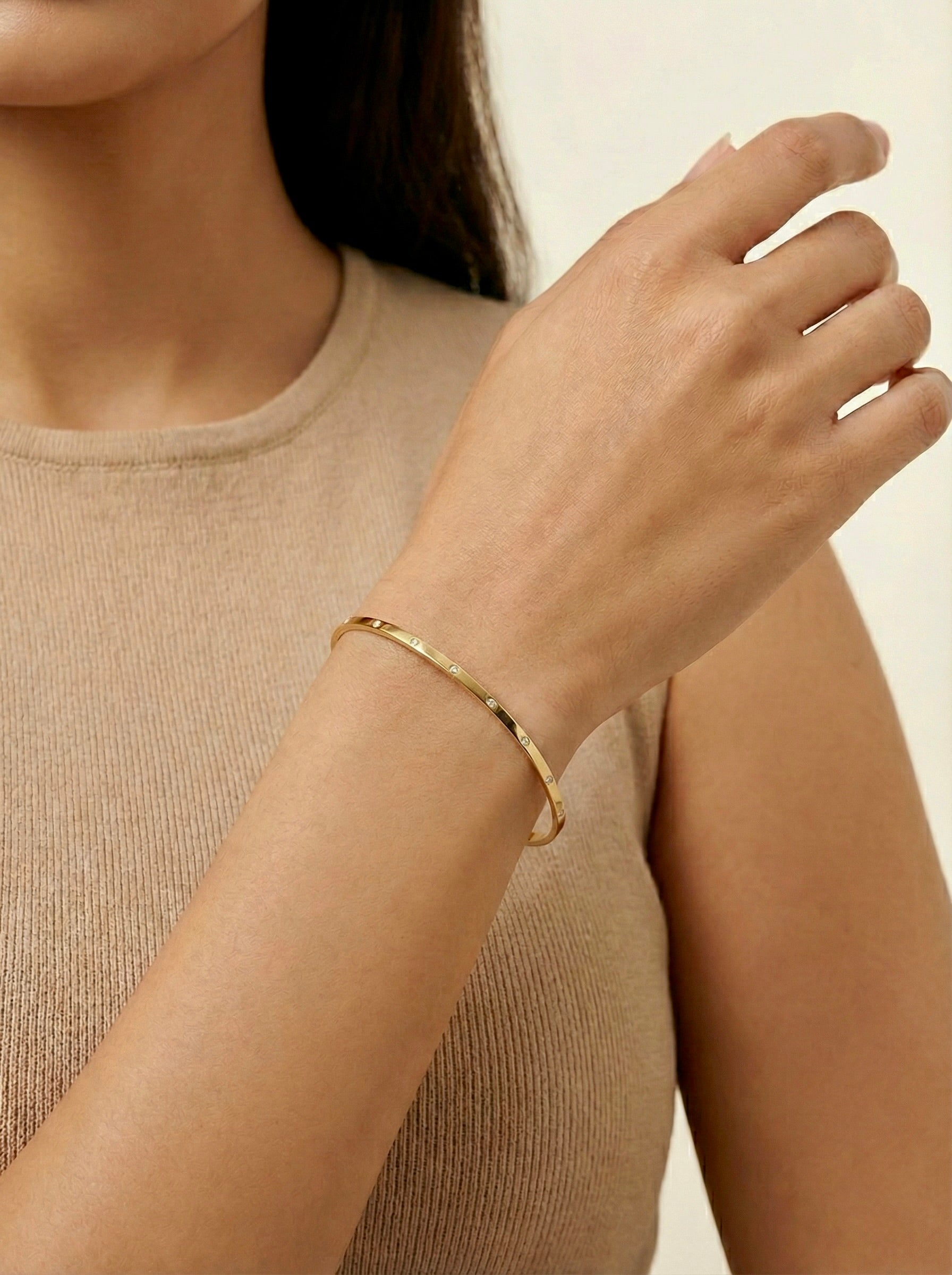 Gold CZ bangle on wrist styled for casual everyday wear
