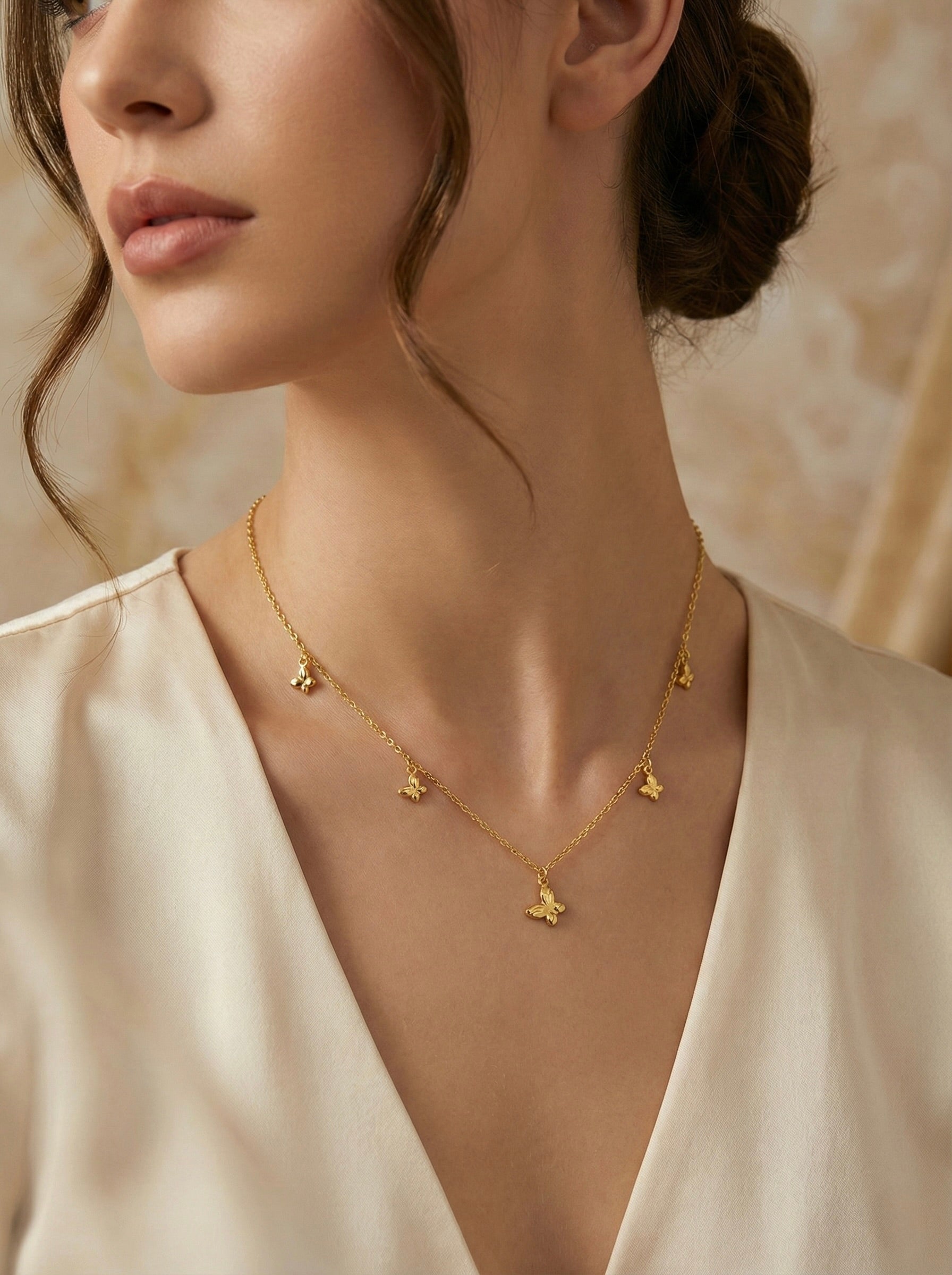 Minimal gold elara butterfly charm necklace styled on model for everyday elegance
