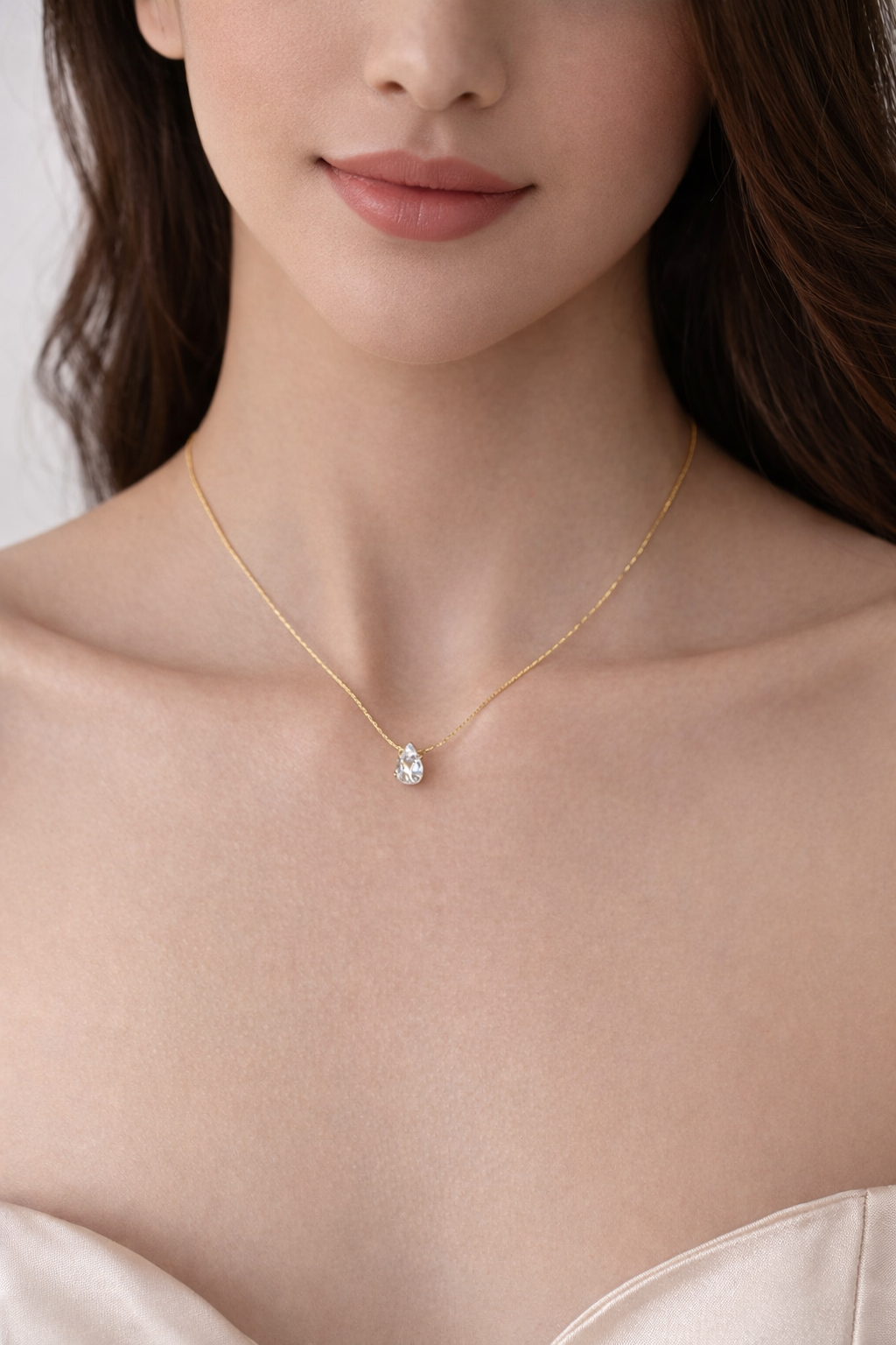 Minimal gold teardrop necklace on model for everyday elegance