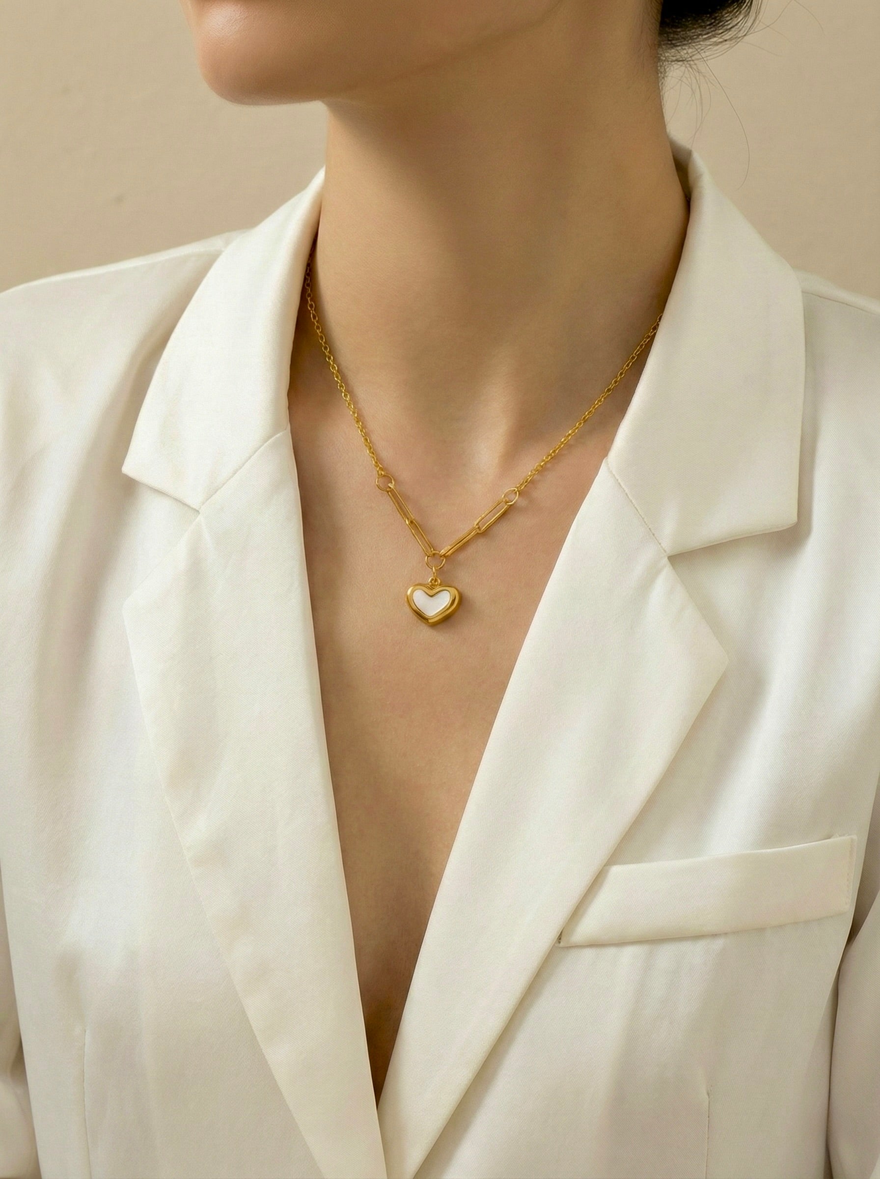 Minimal white heart pendant necklace on model for everyday office elegance