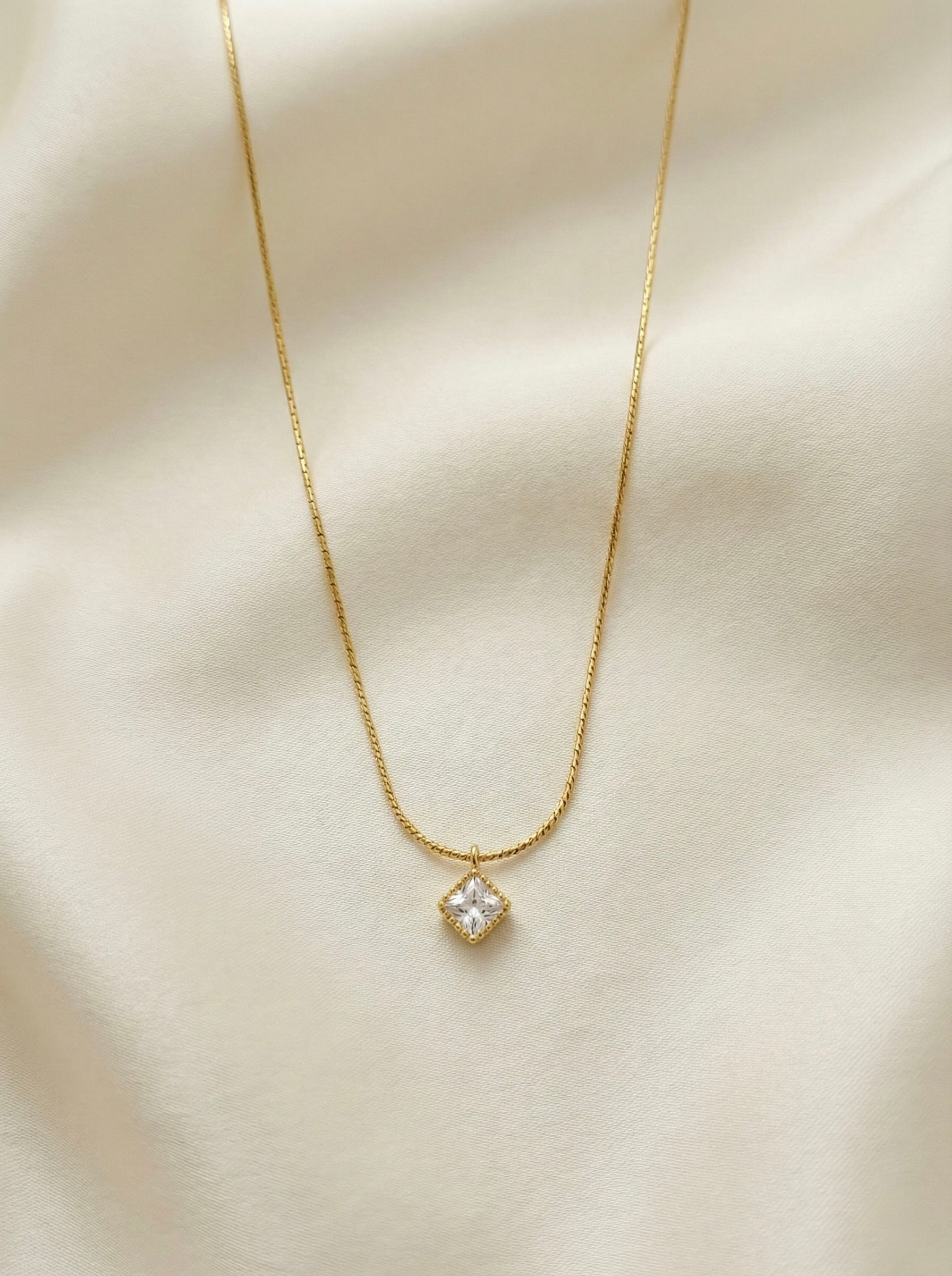 Elegant minimal gold zyelle cz anti tarnish necklace styled with layered chain