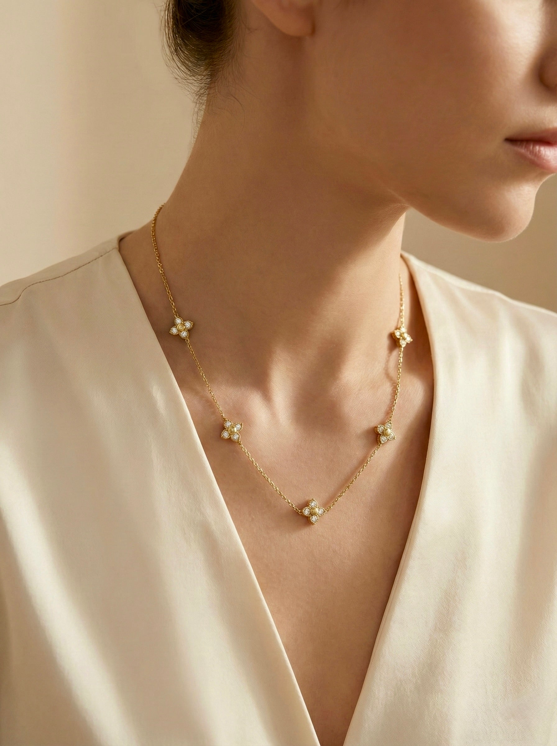 Noor floral station necklace in anti-tarnish gold finish with CZ accents for office wear 