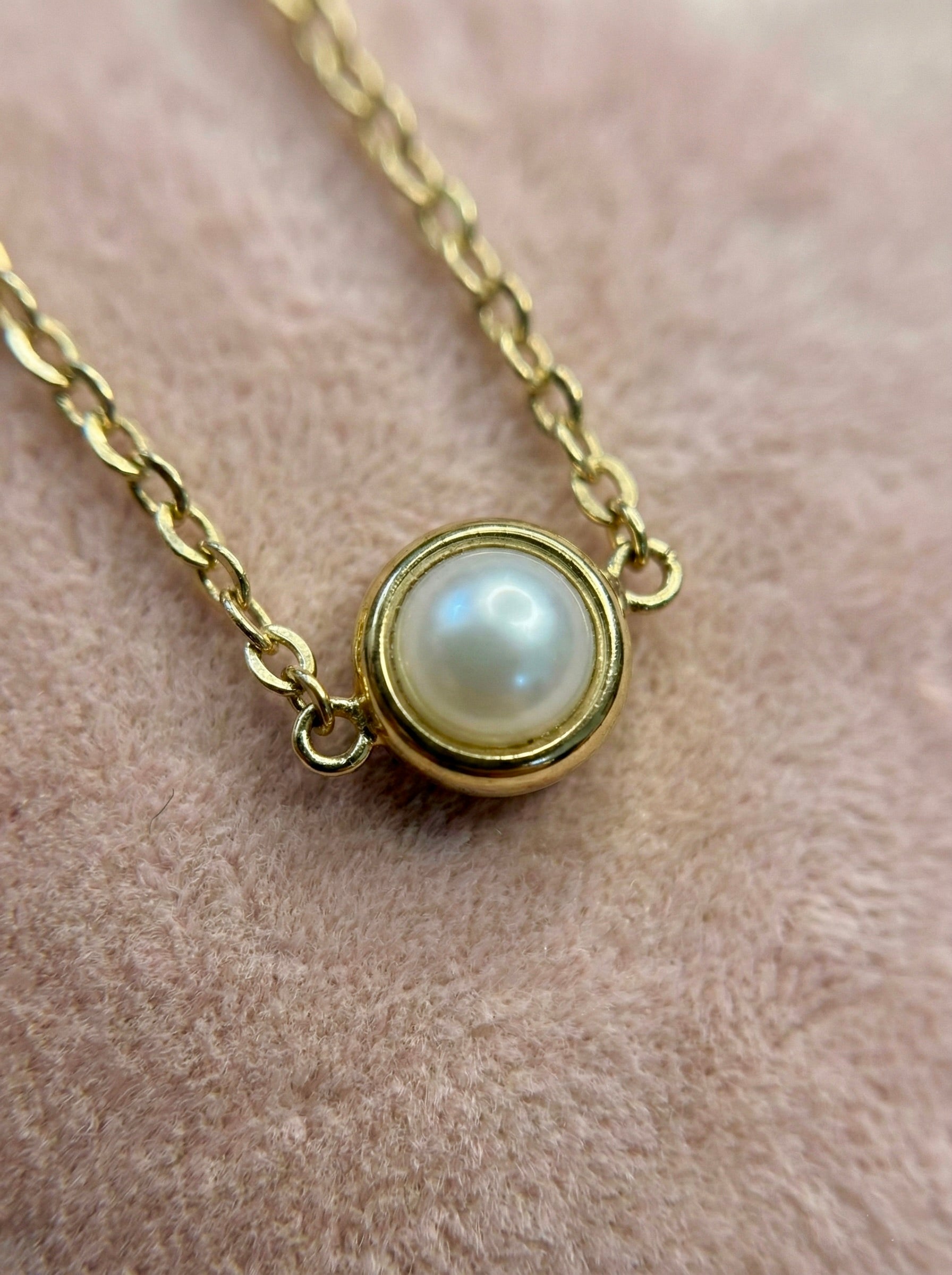 Close-up of Perlisse Aura pearl station gold necklace showing pearl charms