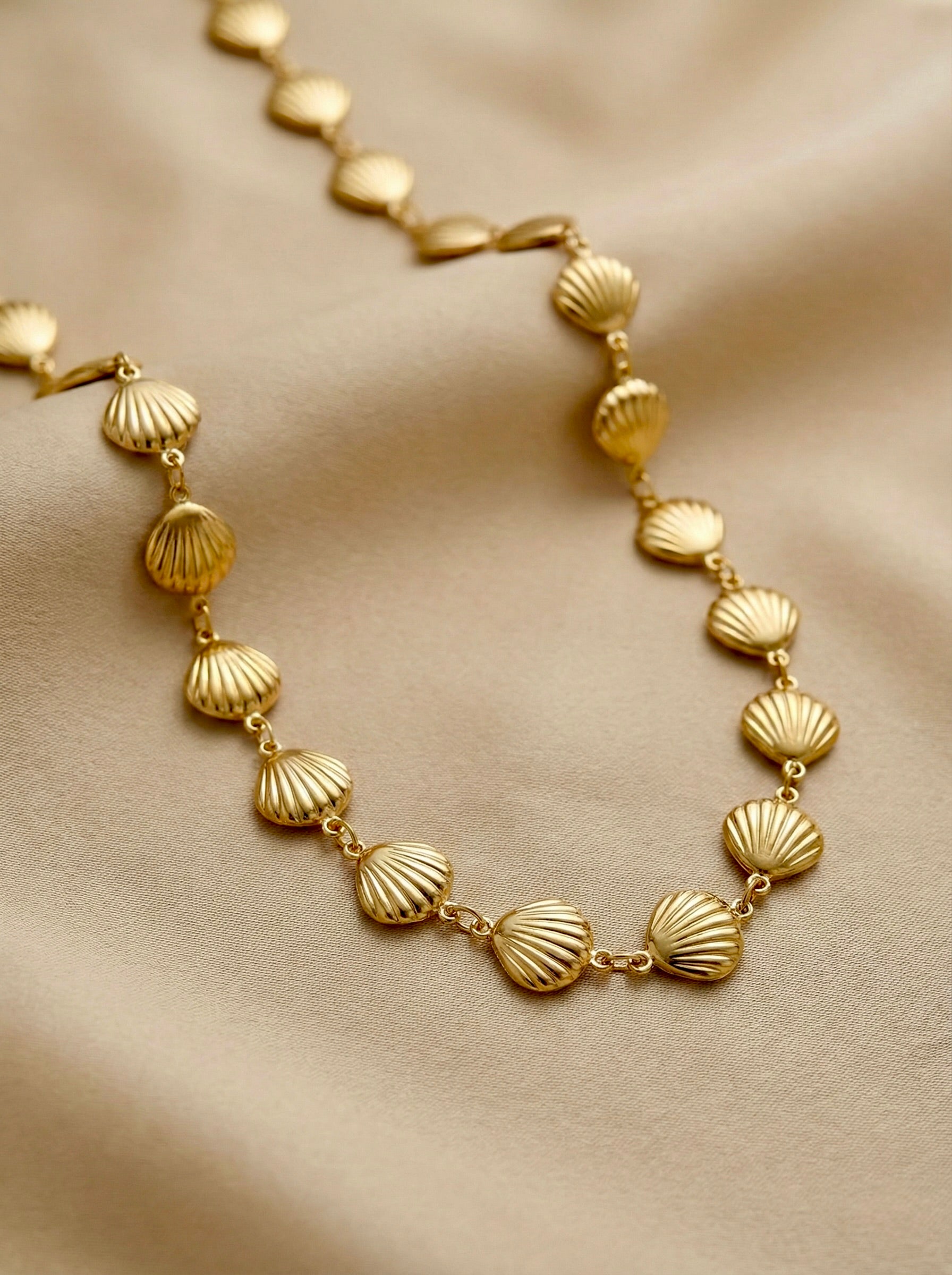 Close-up of shell-inspired gold links on Sephira statement necklace