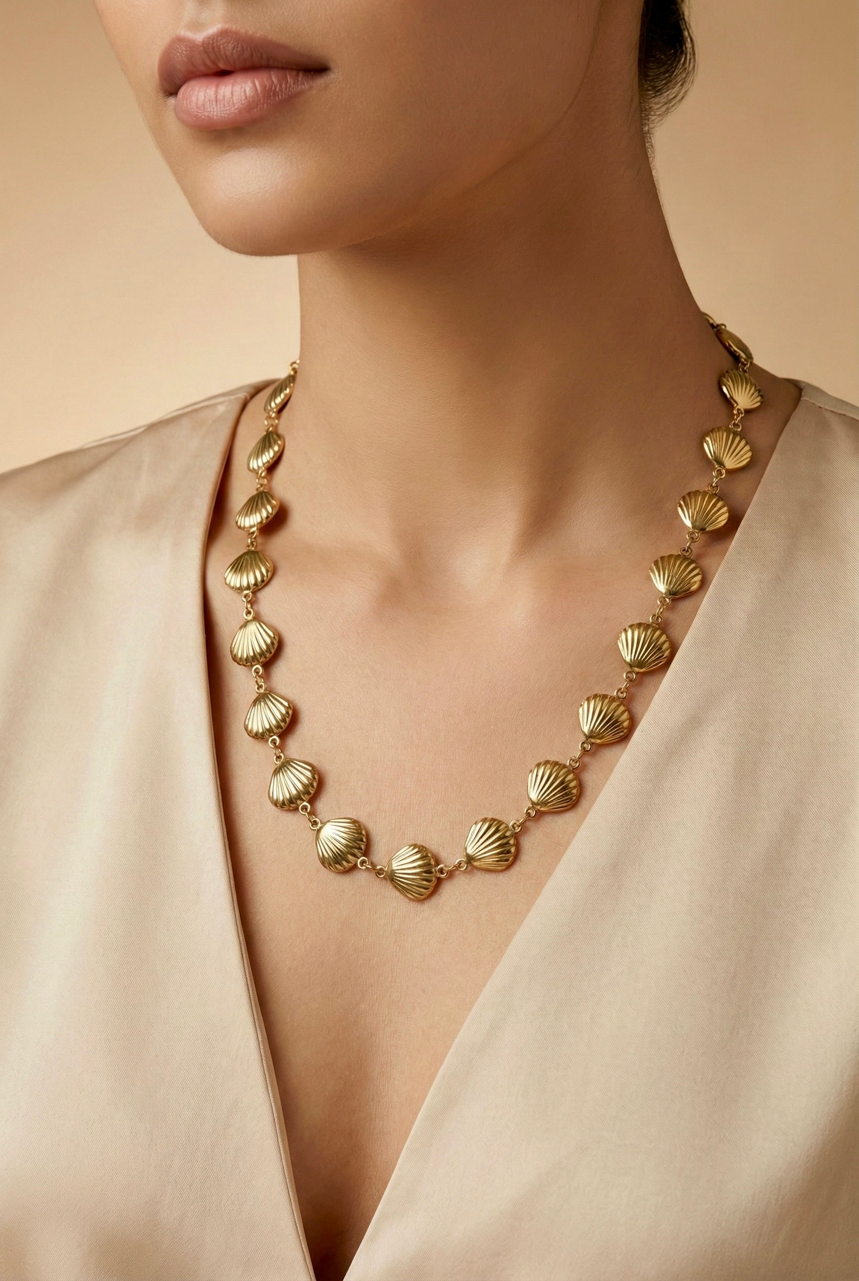 Sephira gold shell link necklace styled on model for party elegance