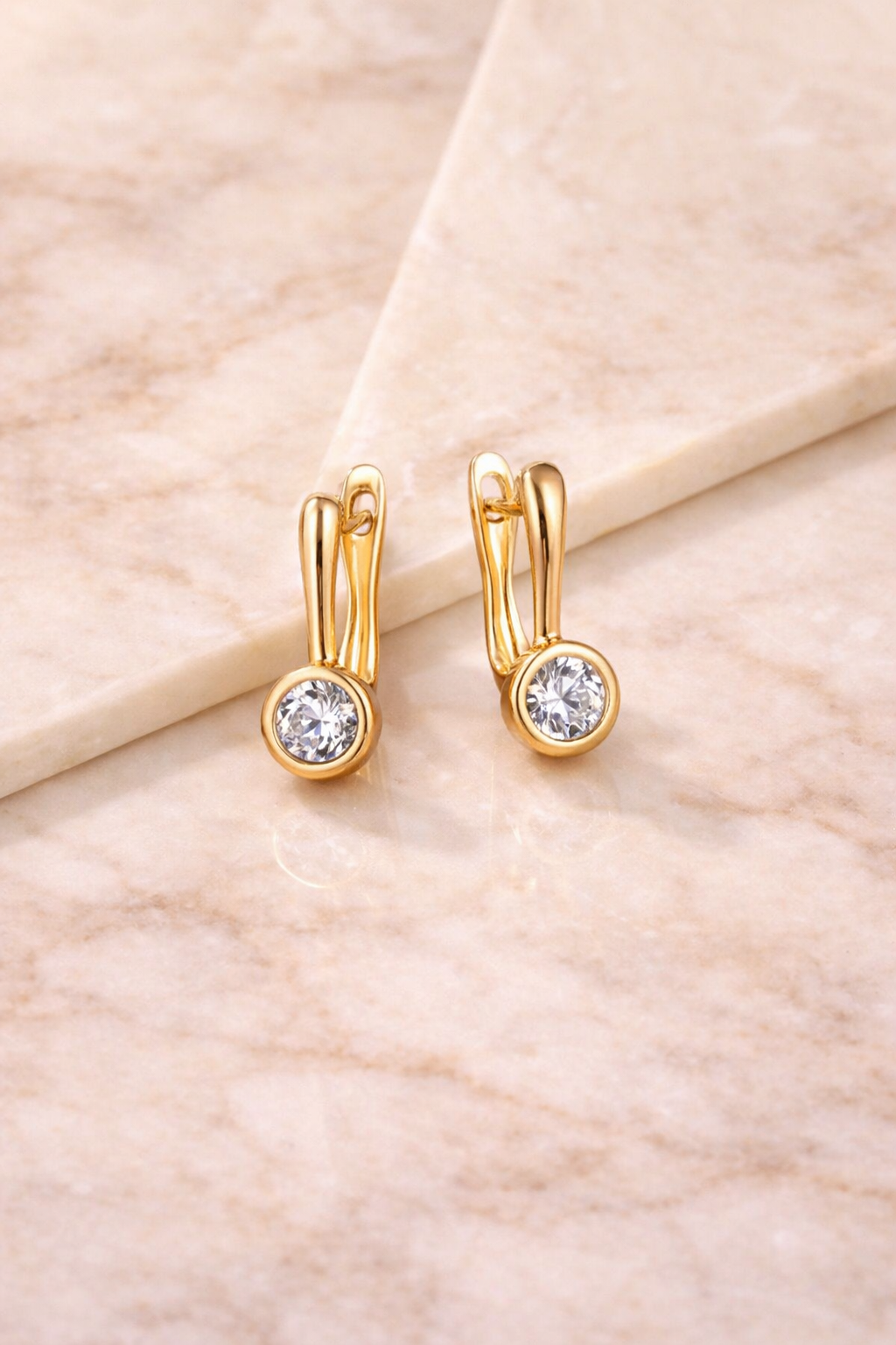 The Solis Huggies gold crystal everyday earrings with anti-tarnish finish for women