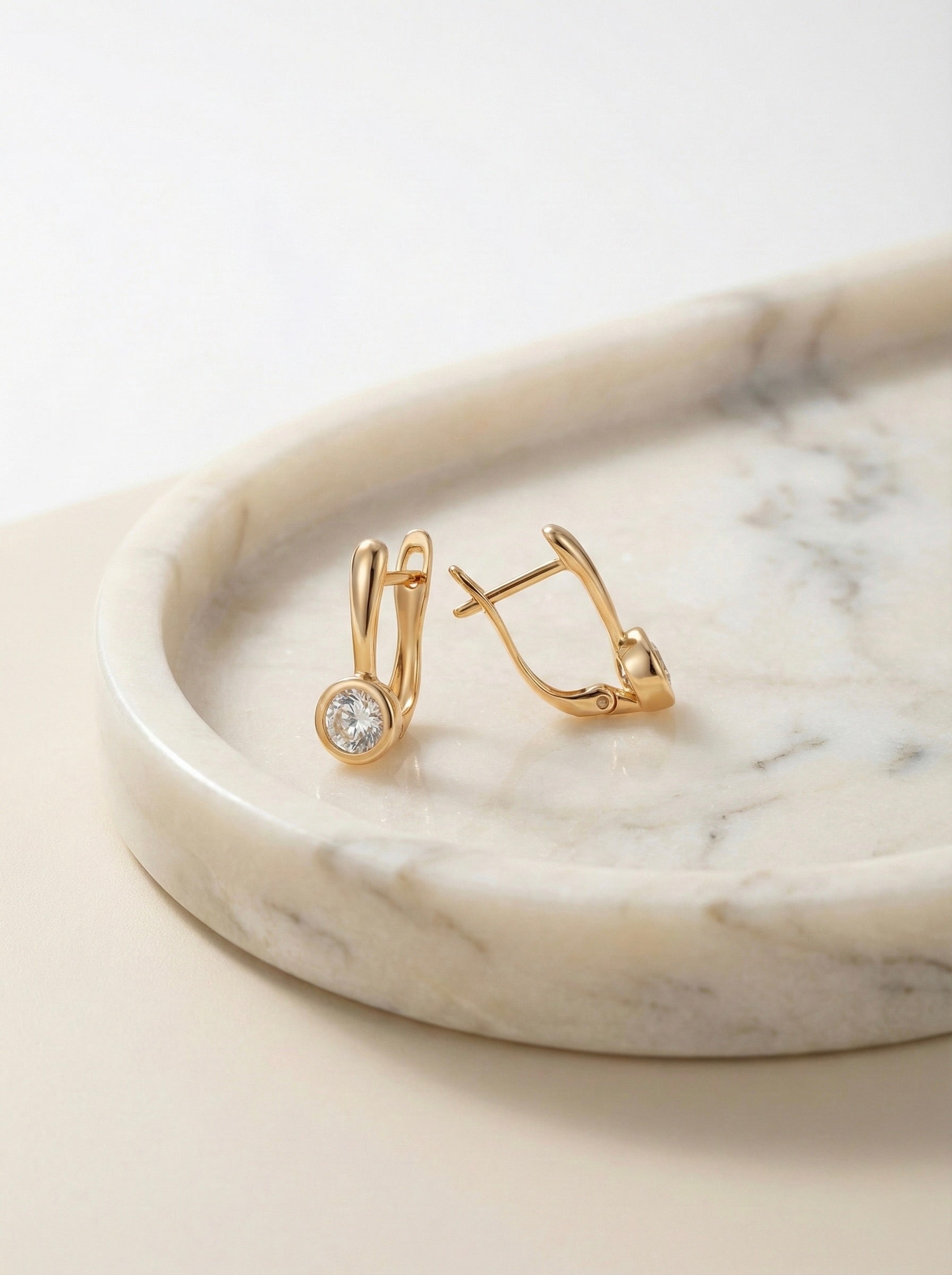 Side view of Solis anti-tarnish gold crystal huggie earrings for women