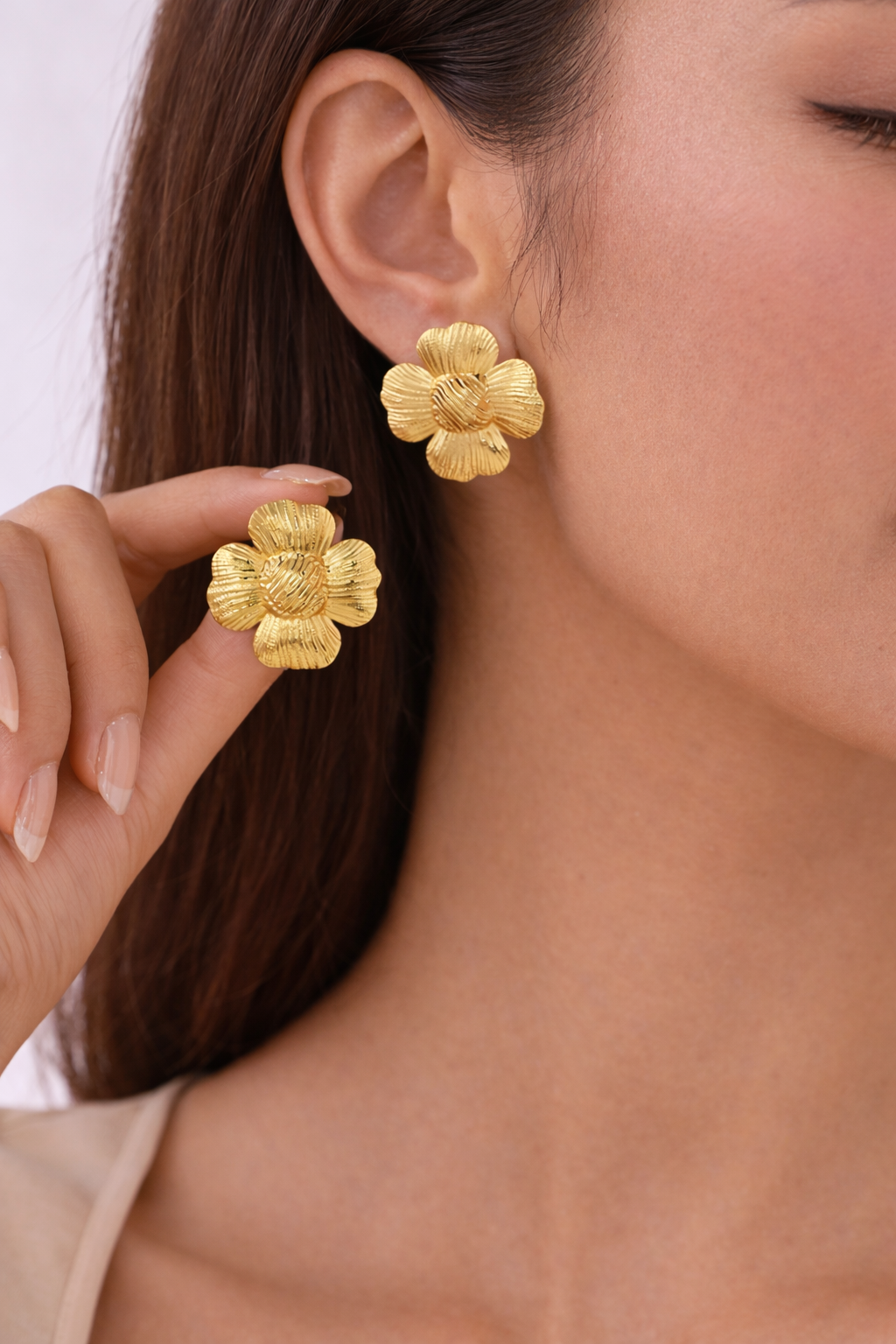 The Bloom Studs gold floral statement earrings worn on model styled for everyday elegance
