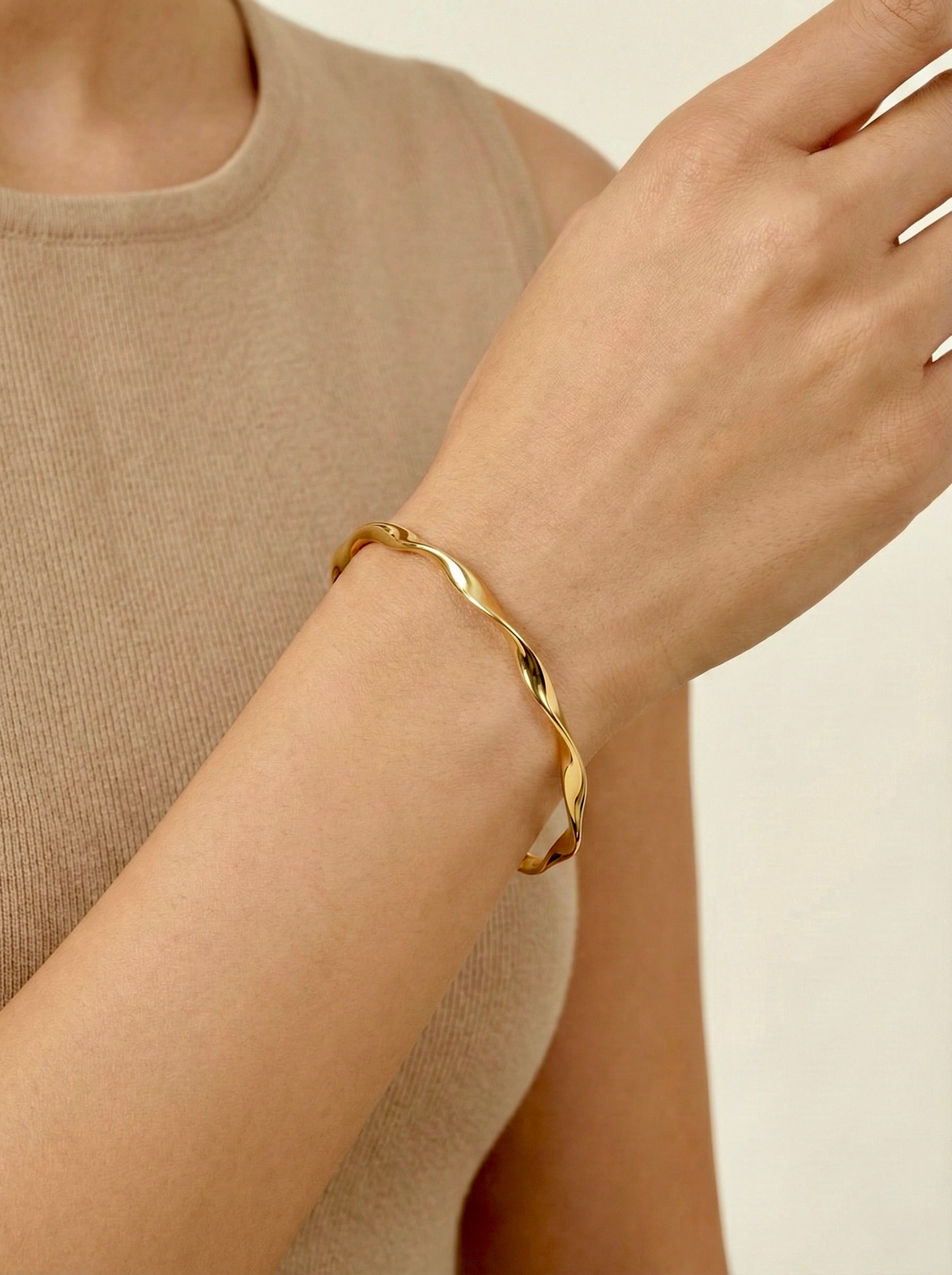 Twylia Twist gold anti-tarnish bangle styled for everyday elegance on a model