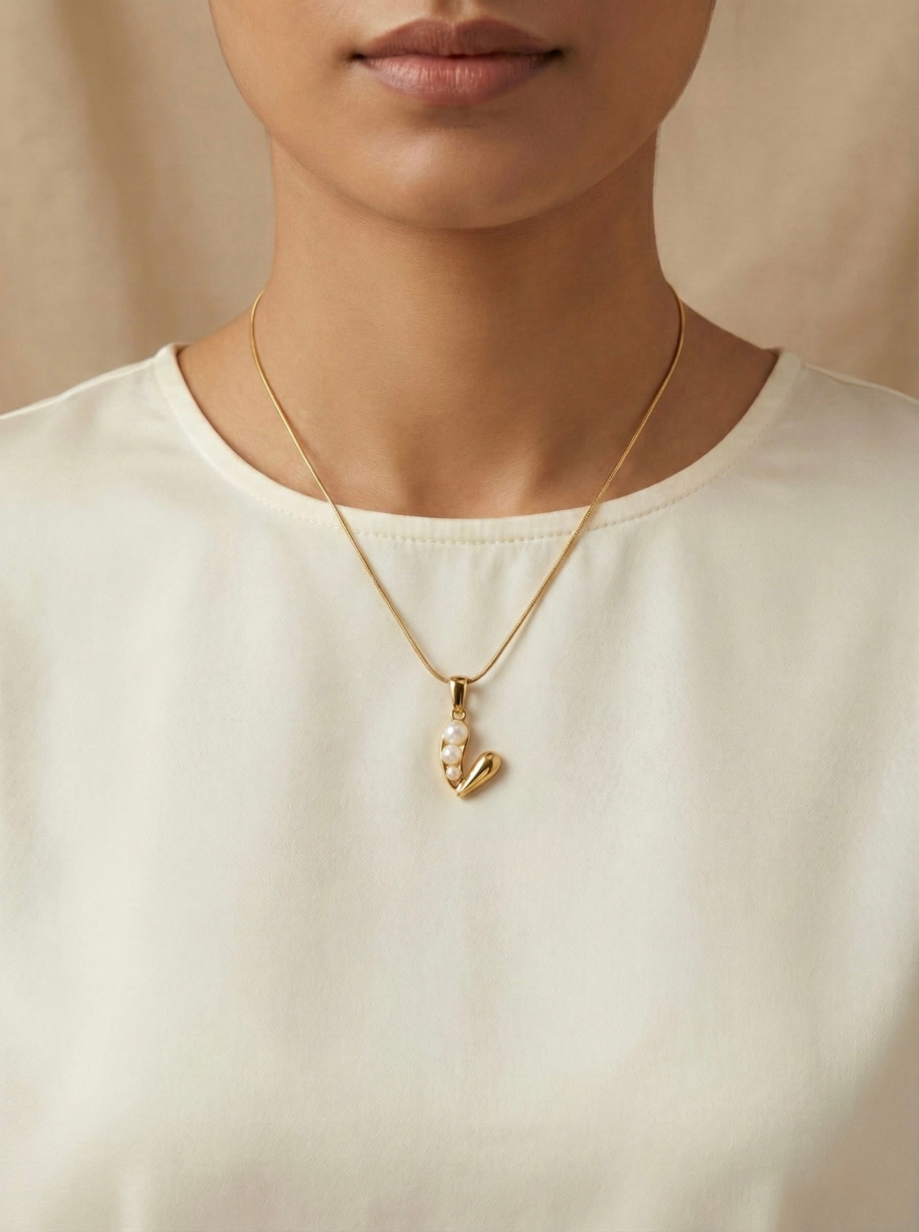 Gold minimal Valiora pearl heart pendant on model for daily style
