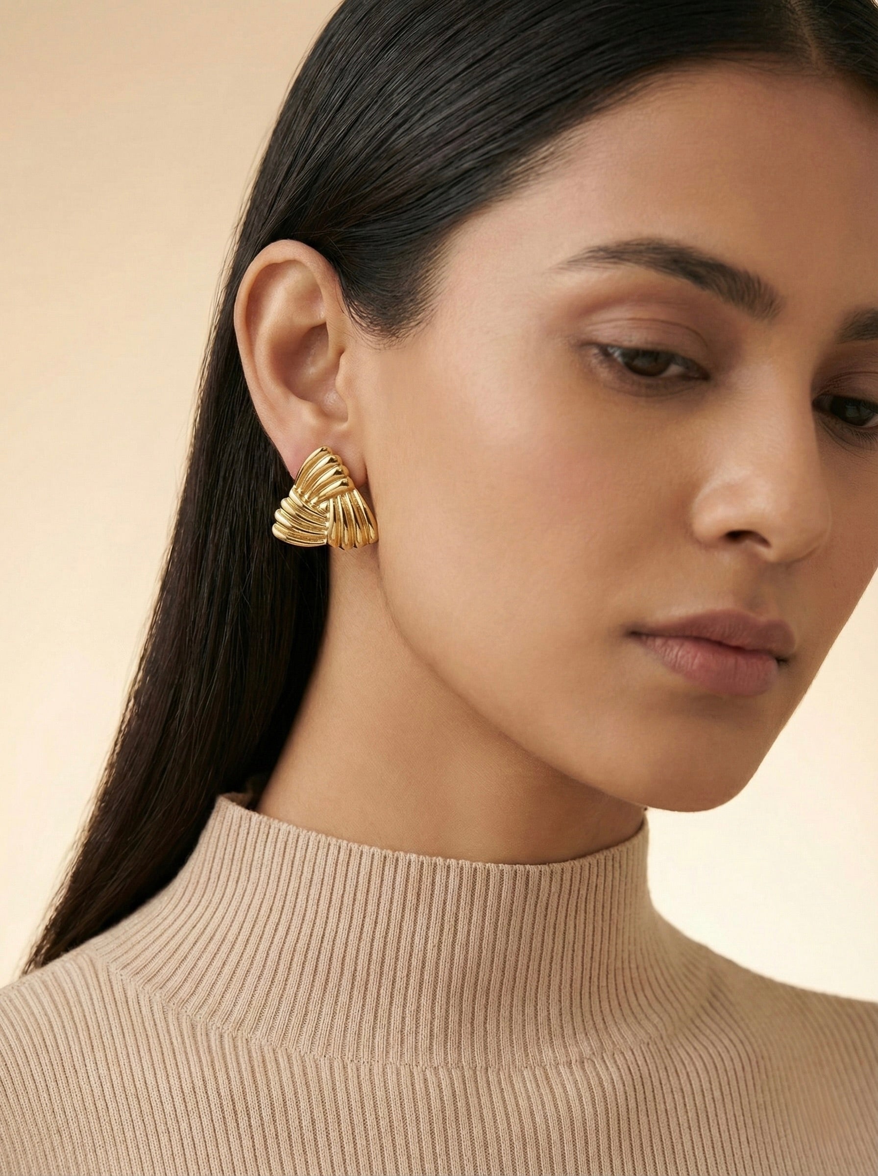 Velmora Sculpted Fan gold studs worn on model styled for everyday elegance