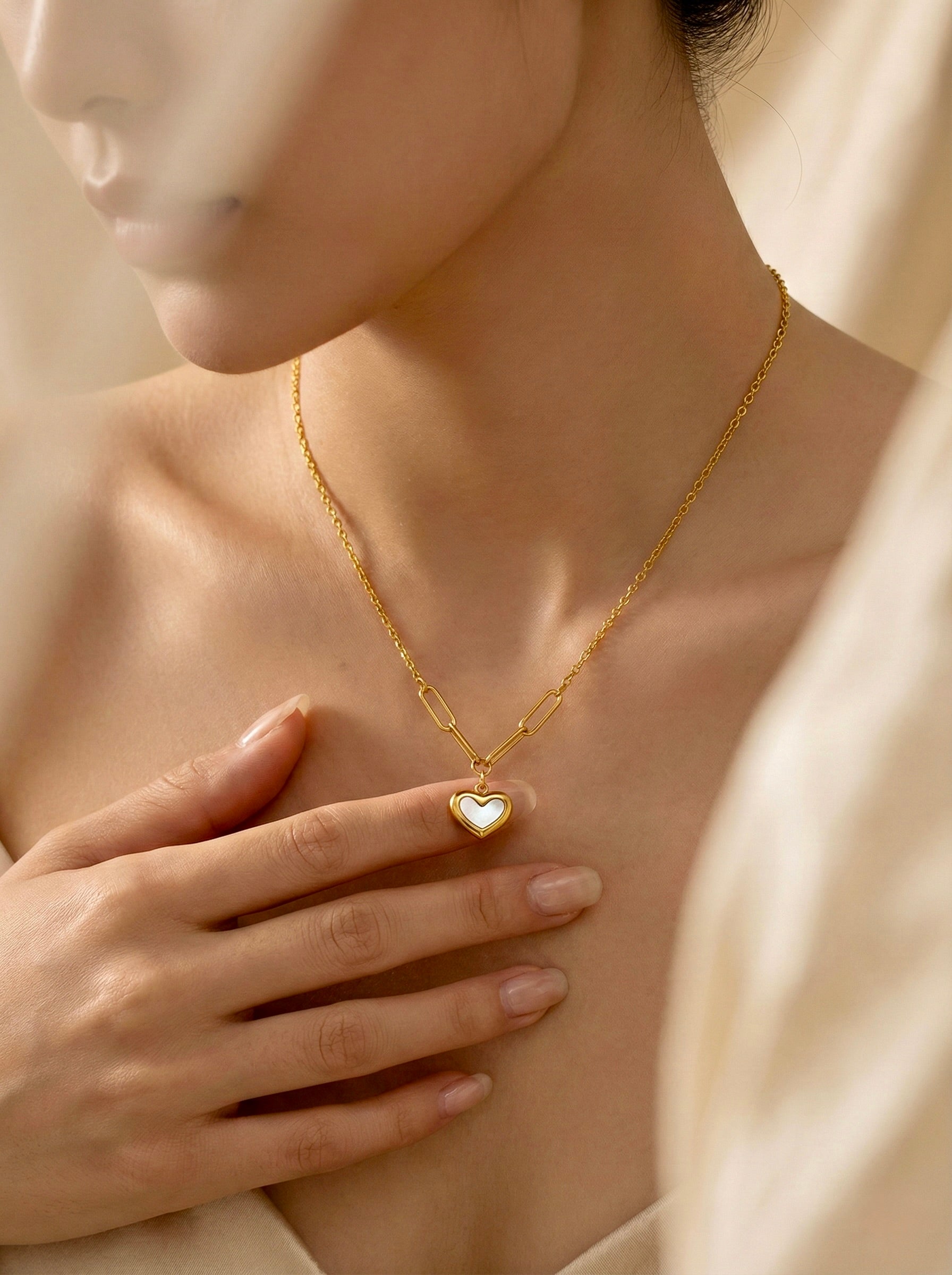 Minimal white enamel heart pendant necklace on model for everyday elegance