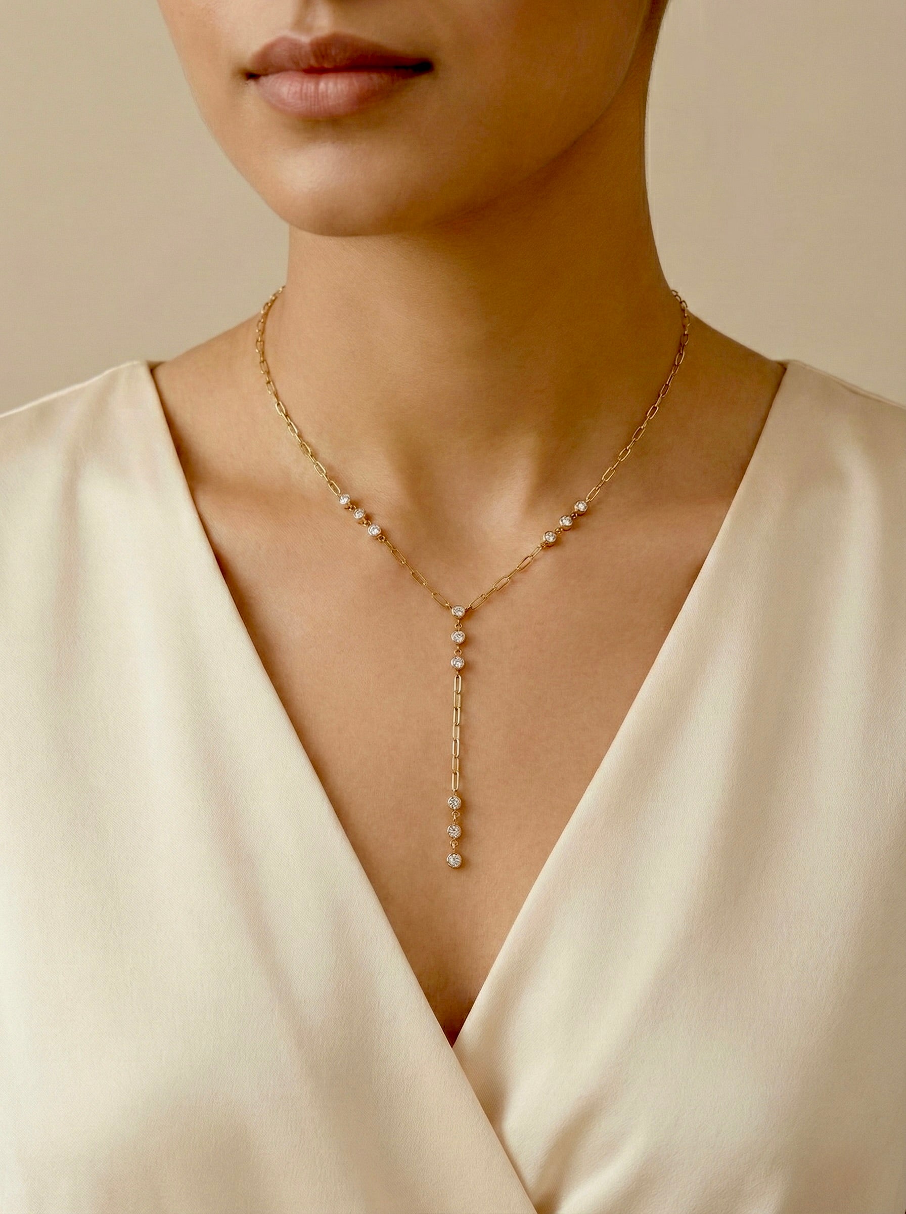 Model wearing anti-tarnish gold elowen CZ station necklace with delicate drop chain on model wearing for party celebrations