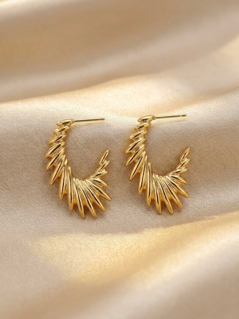 Close-up of Zarielle Sunburst anti-tarnish gold hoop earrings showing sunburst pattern
